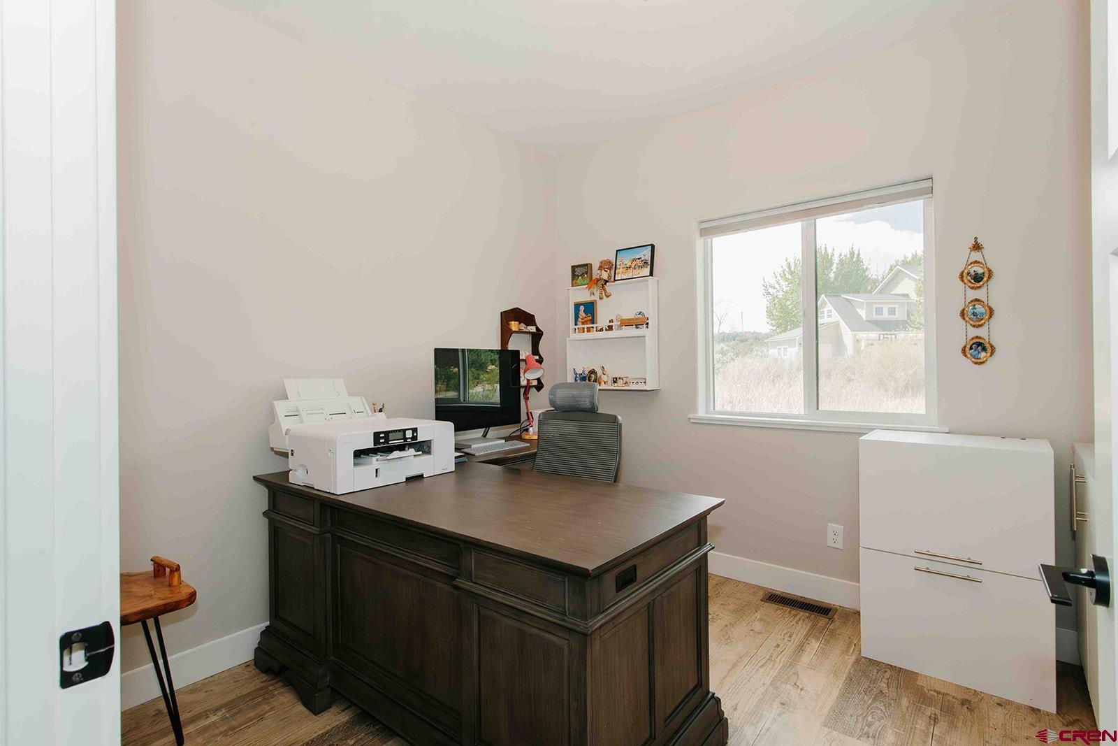 4041 Pioneer Road Montrose, CO 81403 - Photo 26 of 43 a view of a workspace with furniture and a window