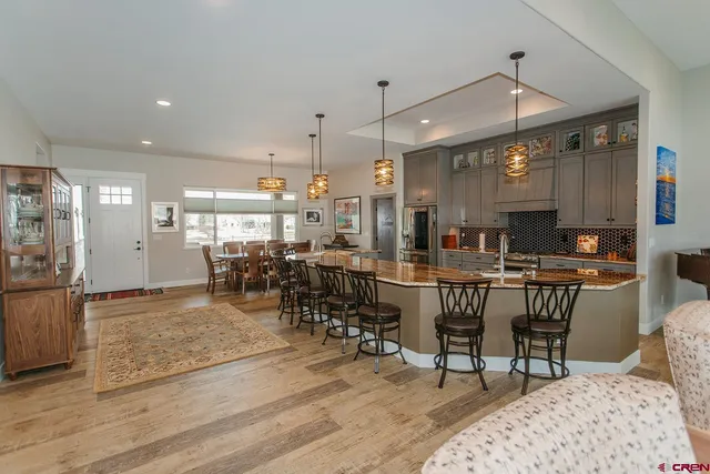 a room with lots of wooden furniture and a view of dining room