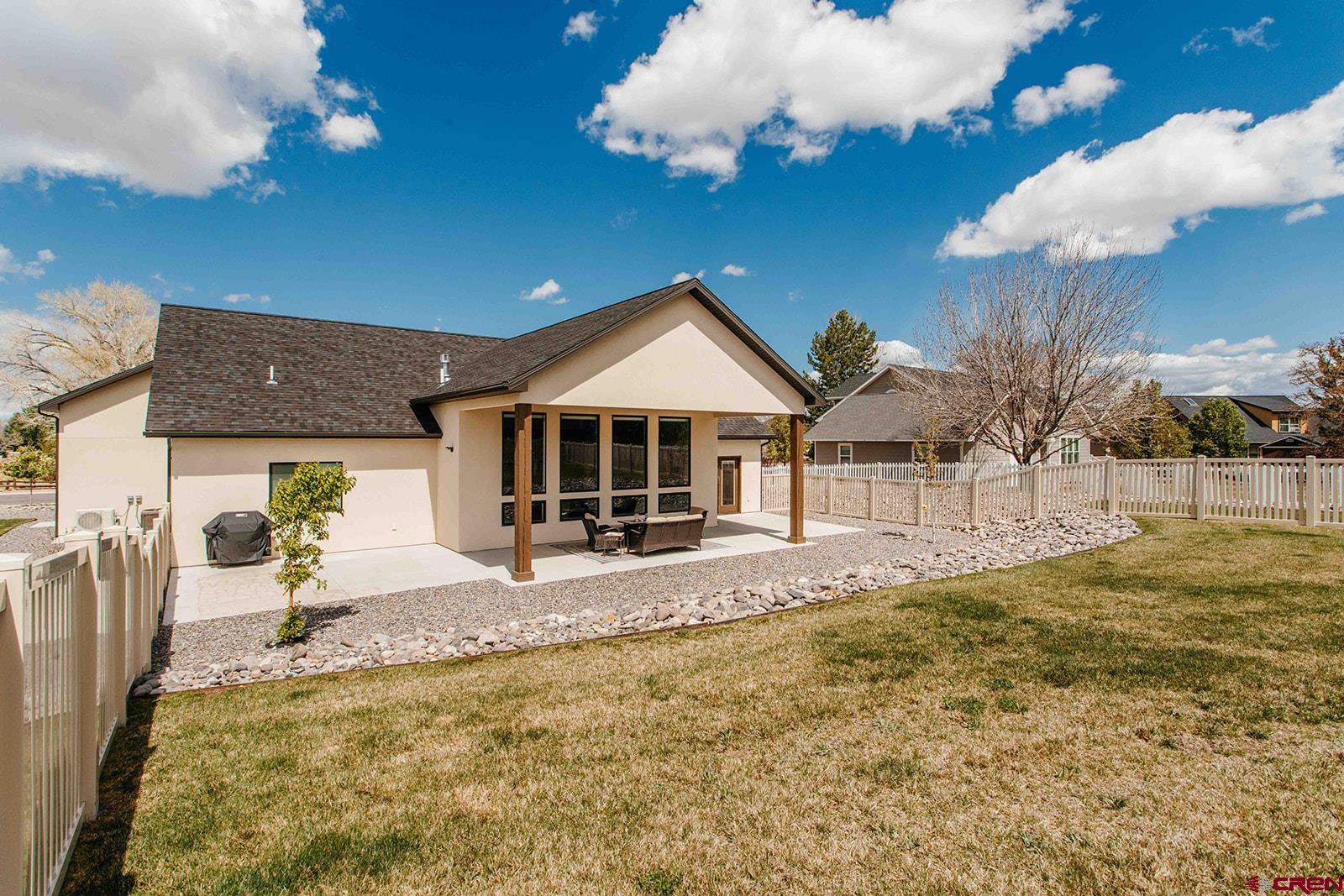 4041 Pioneer Road Montrose, CO 81403 - Photo 32 of 43 a view of a house with a yard