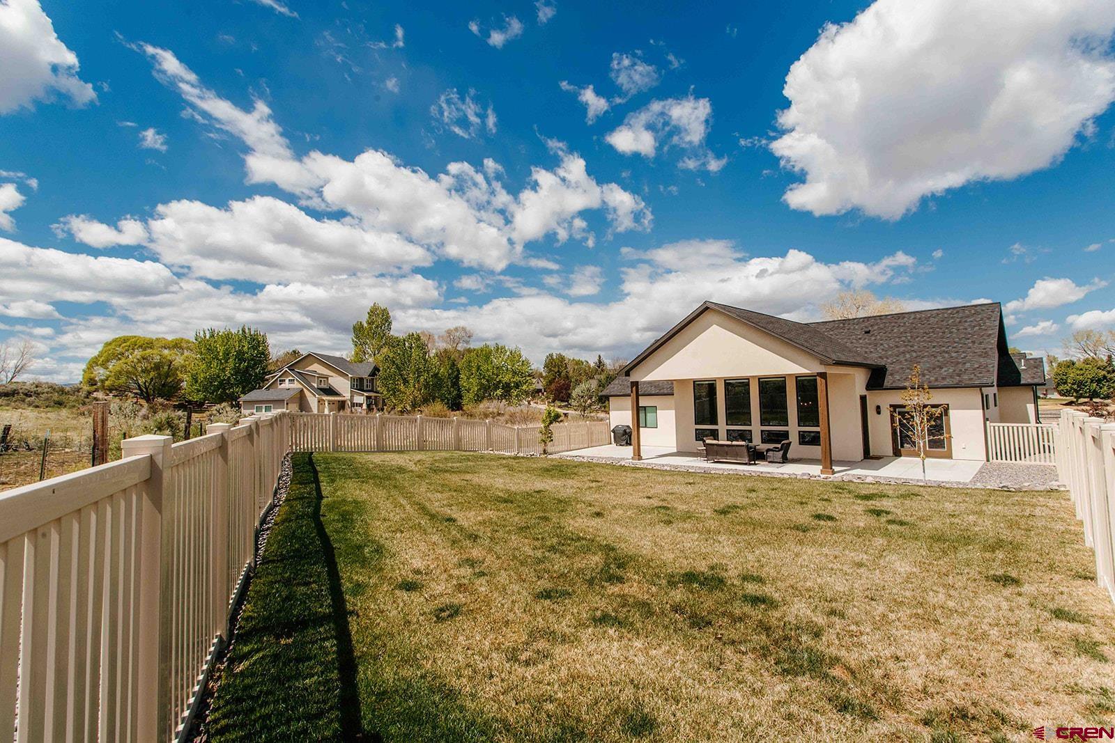 4041 Pioneer Road Montrose, CO 81403 - Photo 33 of 43 a view of a house with a yard
