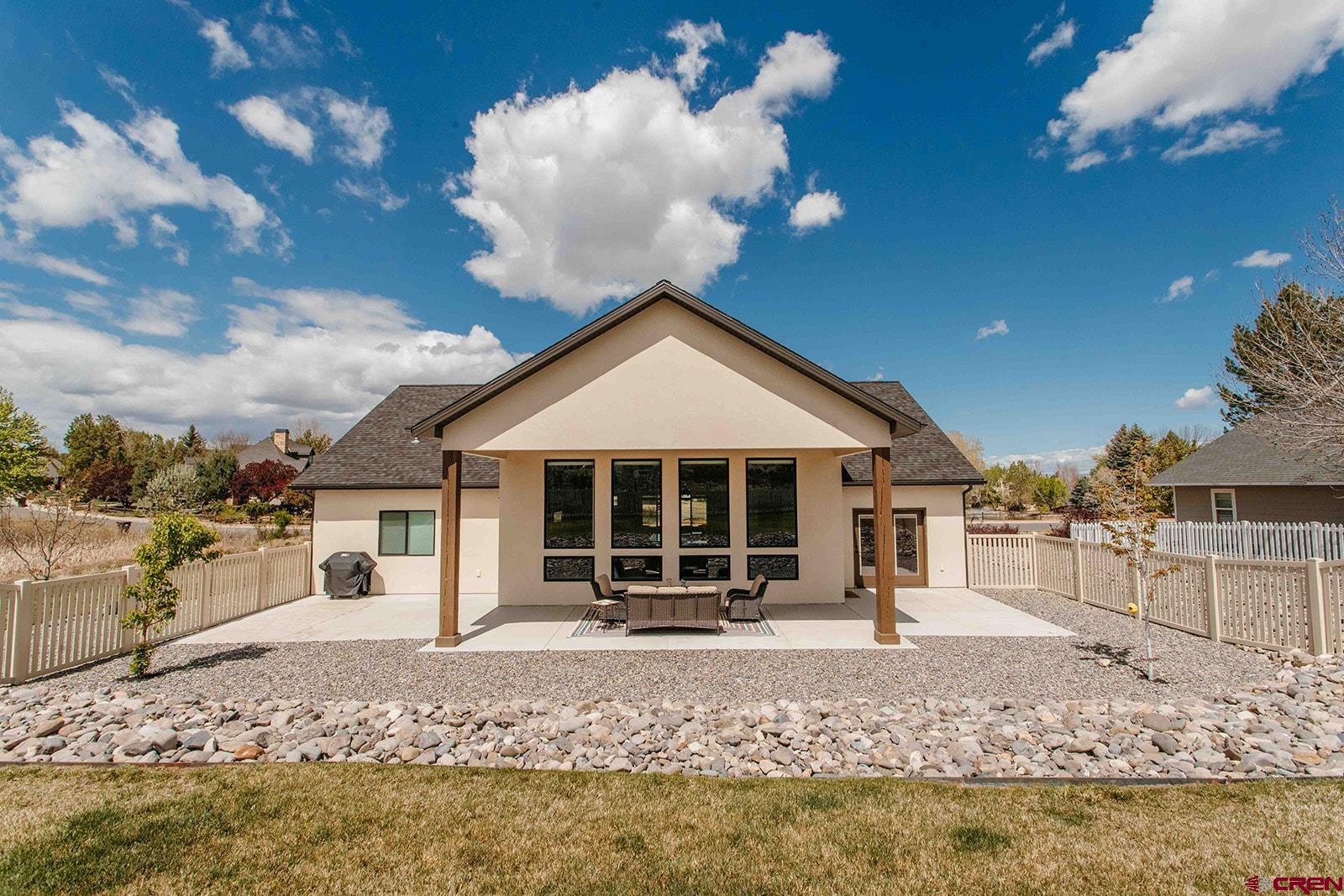 4041 Pioneer Road Montrose, CO 81403 - Photo 34 of 43 a front view of a house with a yard outdoor seating and covered with snow in the background