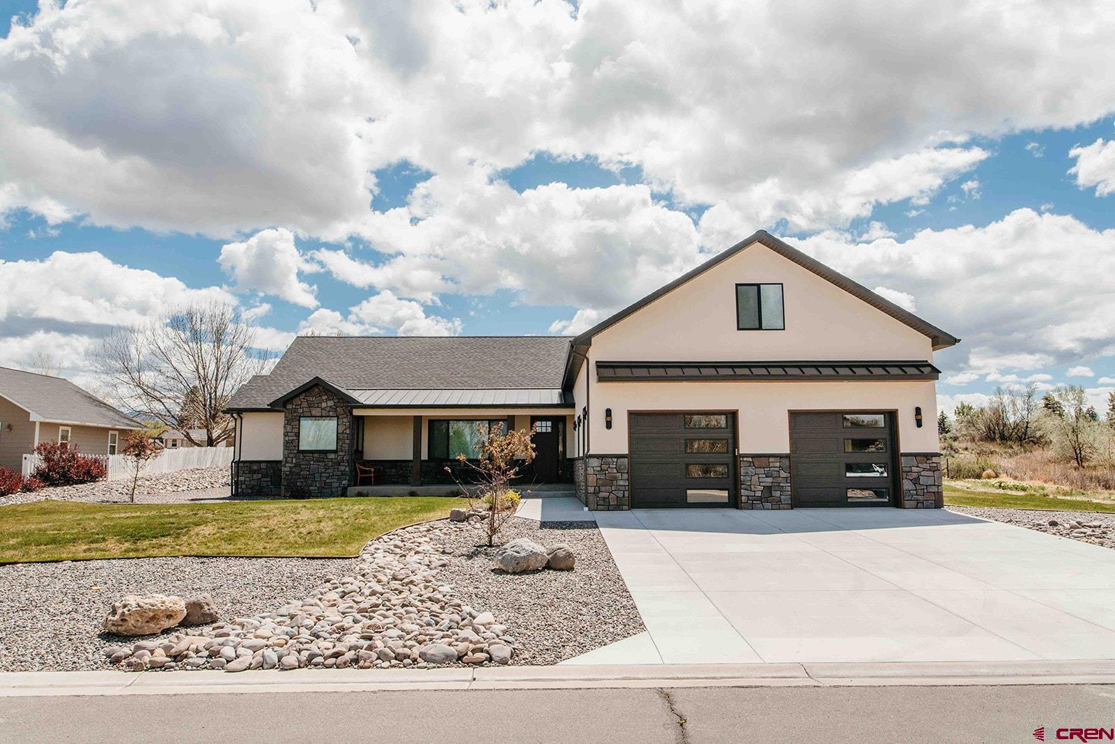 4041 Pioneer Road Montrose, CO 81403 - Photo 38 of 43 a front view of a house with a yard