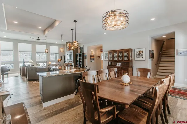 a view of a dining room with furniture wooden floor and chandelier