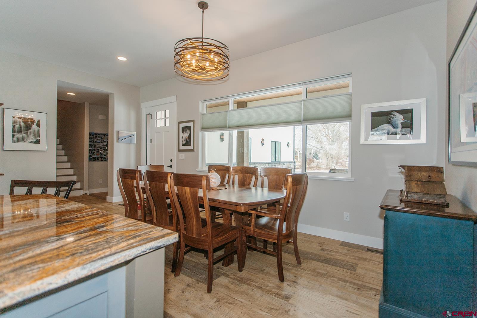 4041 Pioneer Road Montrose, CO 81403 - Photo 10 of 43 a view of a dining room with furniture window and wooden floor