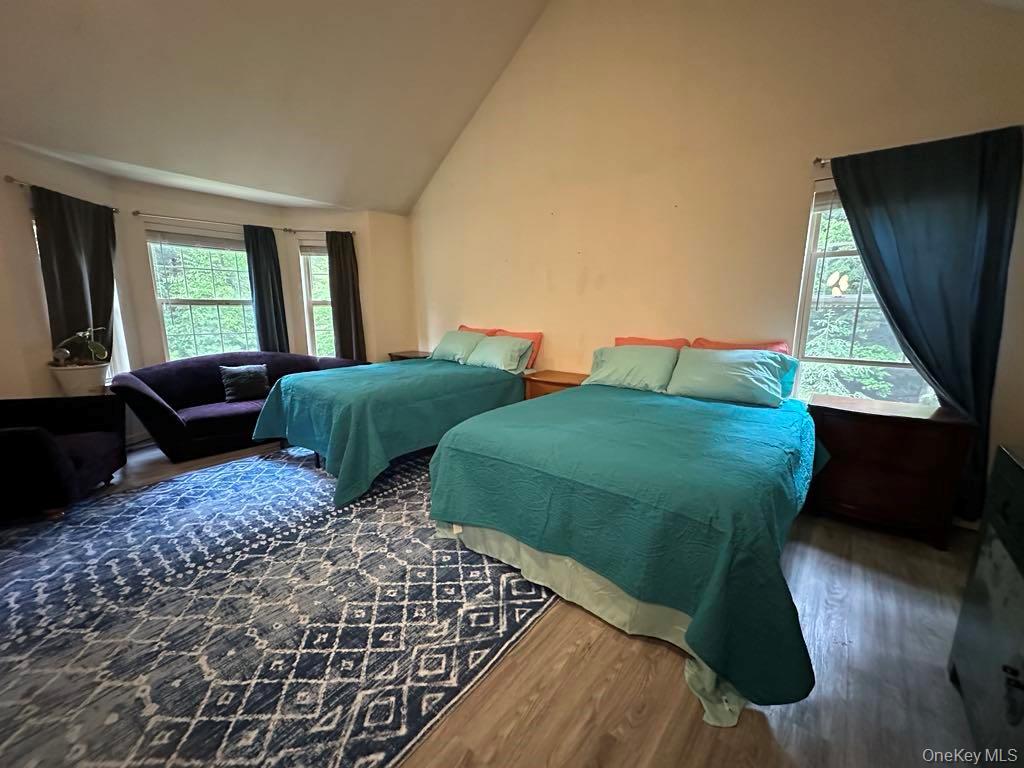 556 Airport Road Swan Lake, NY 12783 - Photo 14 of 22 a bedroom with two beds and a large window