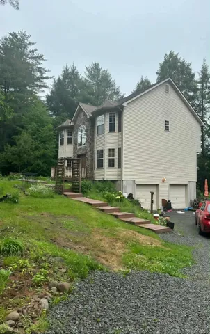 a view of a house with backyard and sitting area