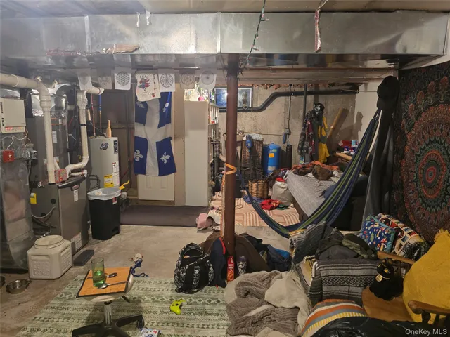 a view of a storage room with water heater and racks