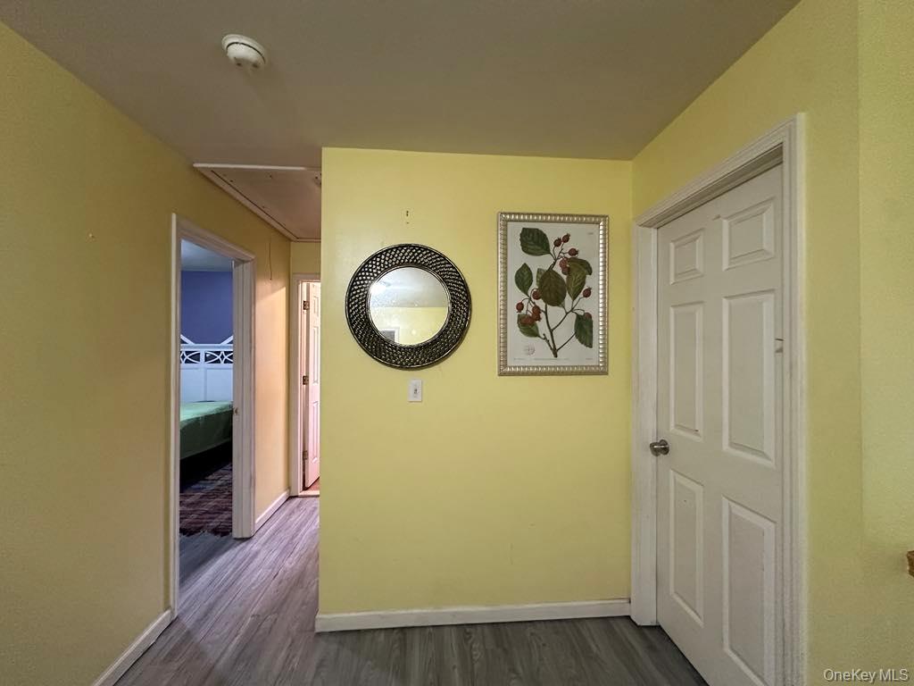 556 Airport Road Swan Lake, NY 12783 - Photo 9 of 22 a view of a hallway with wooden floor