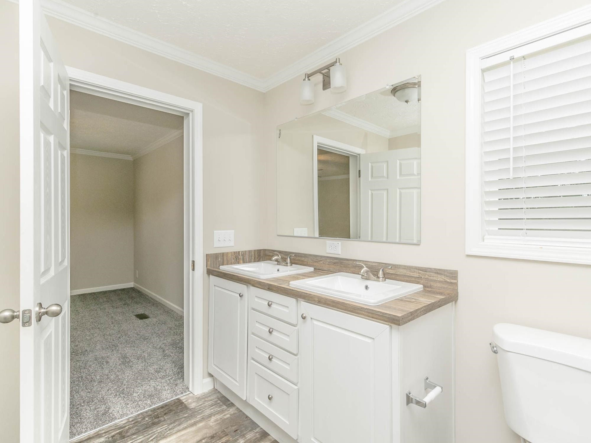 1650 Moulton Road Louisburg, NC 27549 - Photo 15 of 23 a bathroom with a granite countertop sink and a mirror