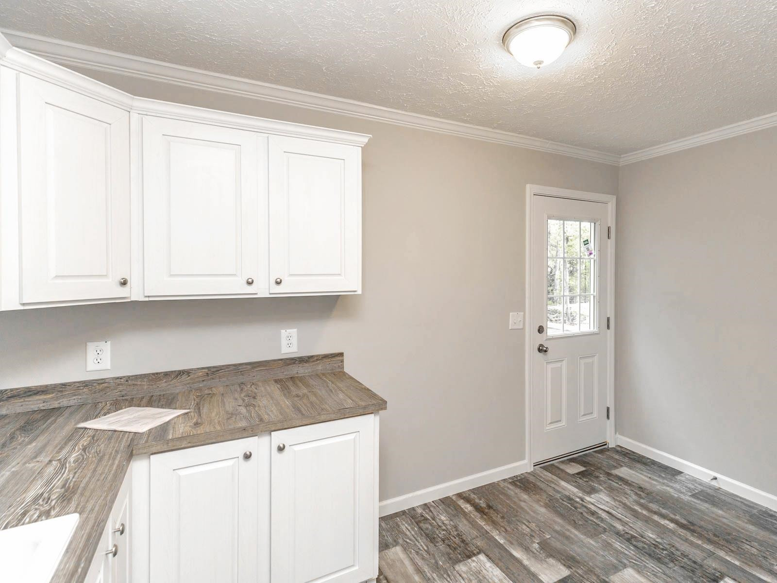1650 Moulton Road Louisburg, NC 27549 - Photo 18 of 23 a kitchen with granite countertop white cabinets and sink