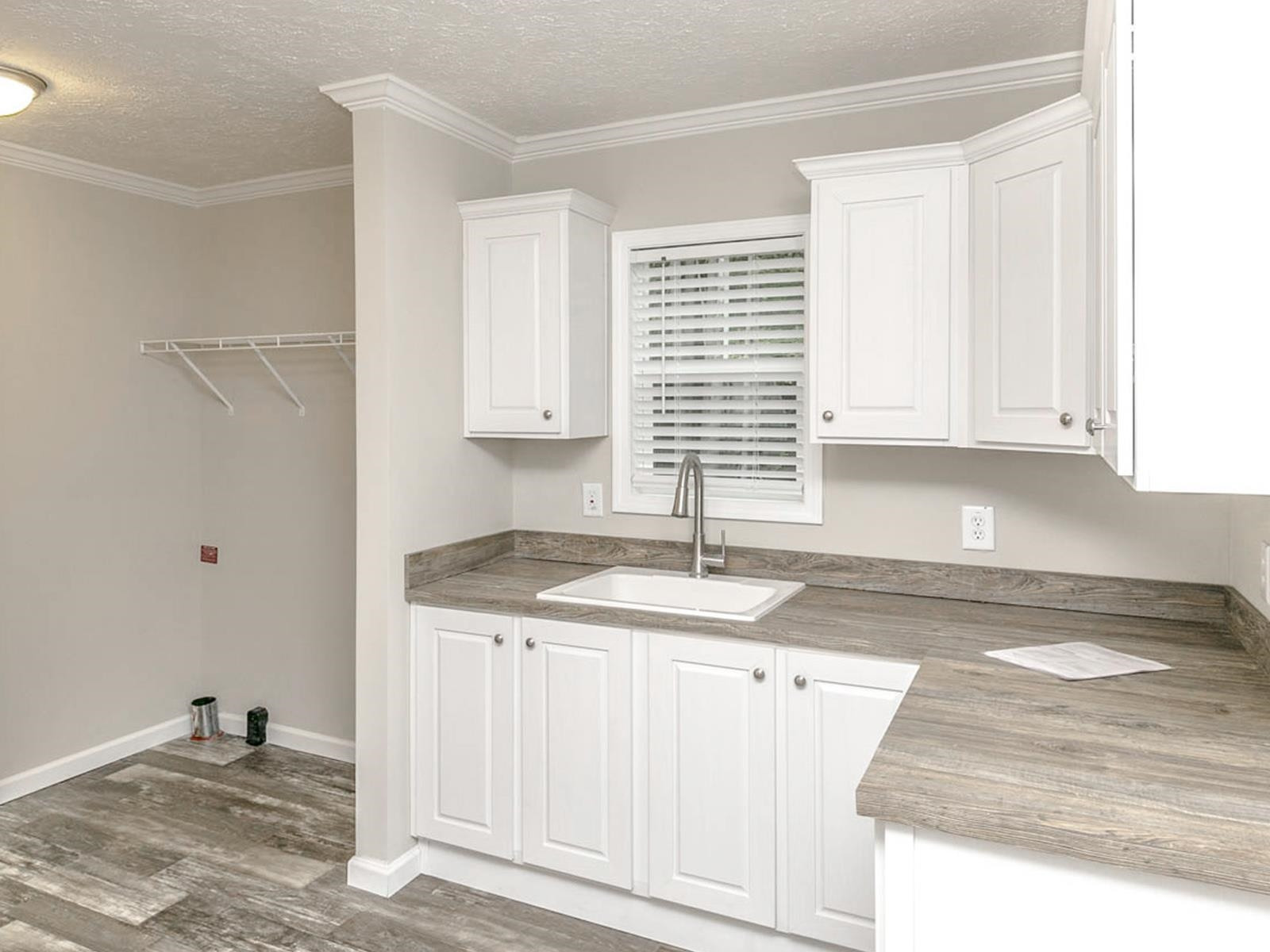 1650 Moulton Road Louisburg, NC 27549 - Photo 19 of 23 a kitchen with granite countertop a sink and a white cabinets