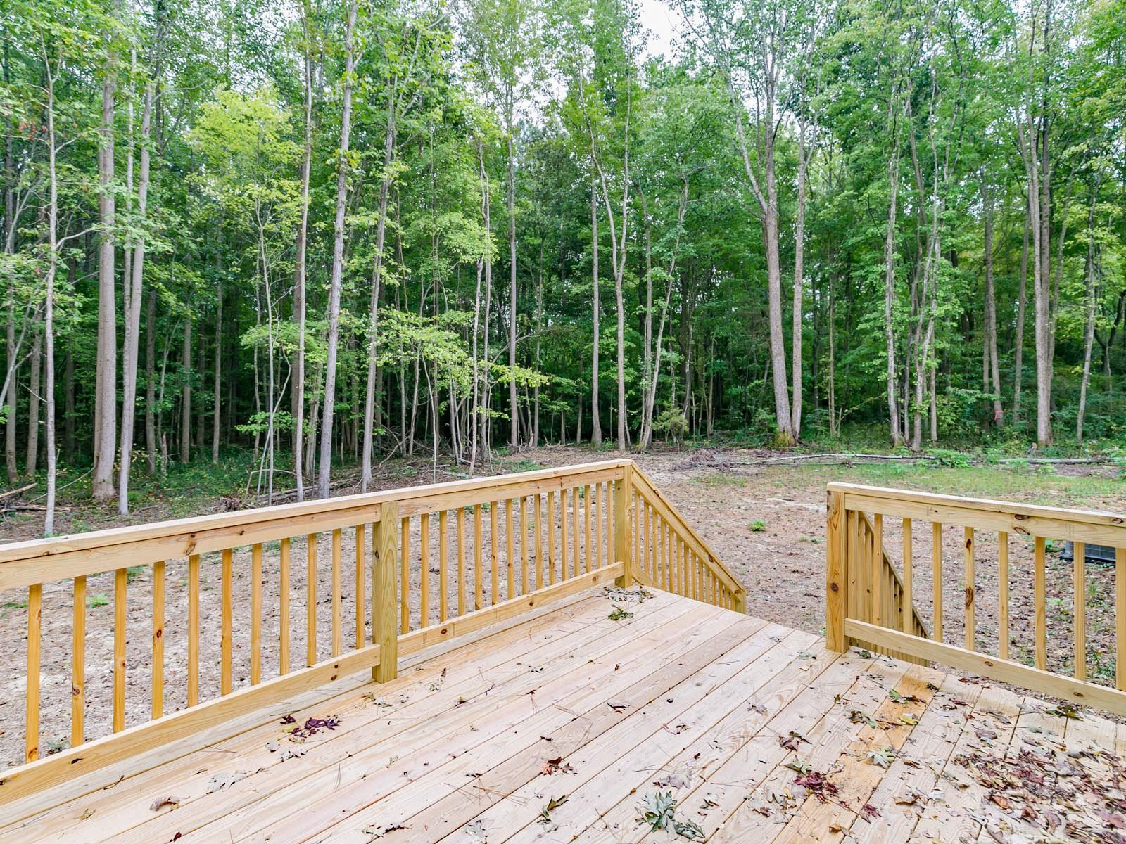1650 Moulton Road Louisburg, NC 27549 - Photo 21 of 23 a view of a wooden deck with a trees