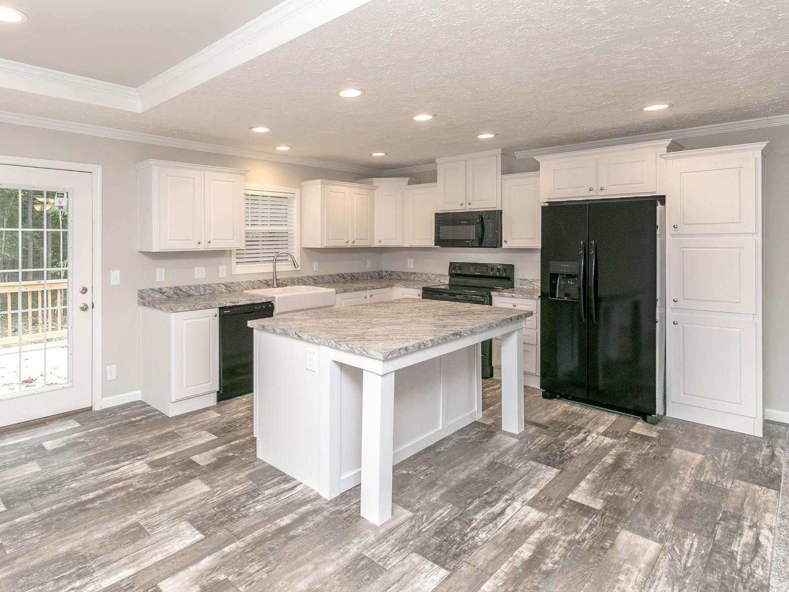 1650 Moulton Road Louisburg, NC 27549 - Photo 3 of 23 a kitchen with a stove a refrigerator and a sink