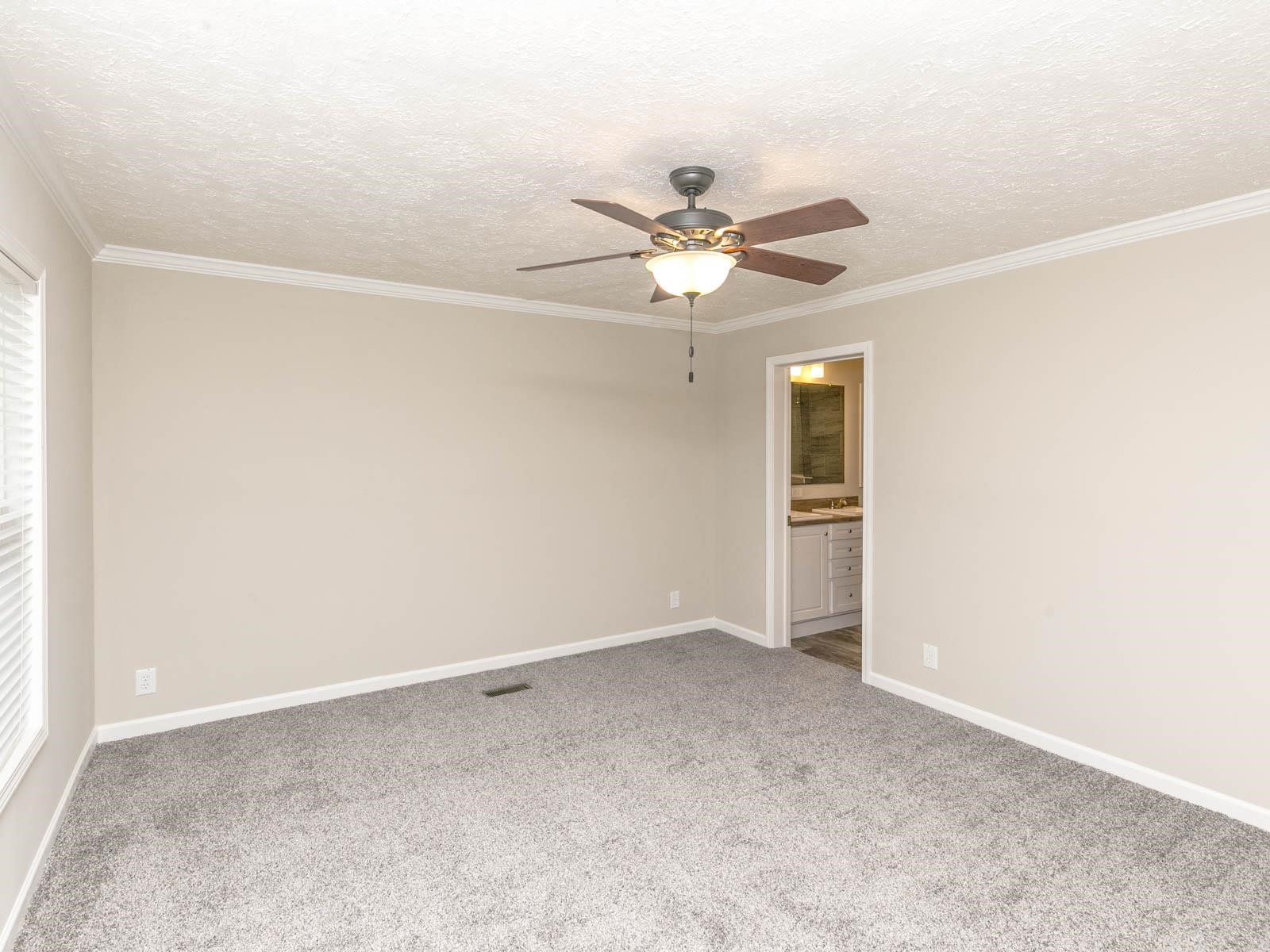 1650 Moulton Road Louisburg, NC 27549 - Photo 7 of 23 an empty room with a window and a fan