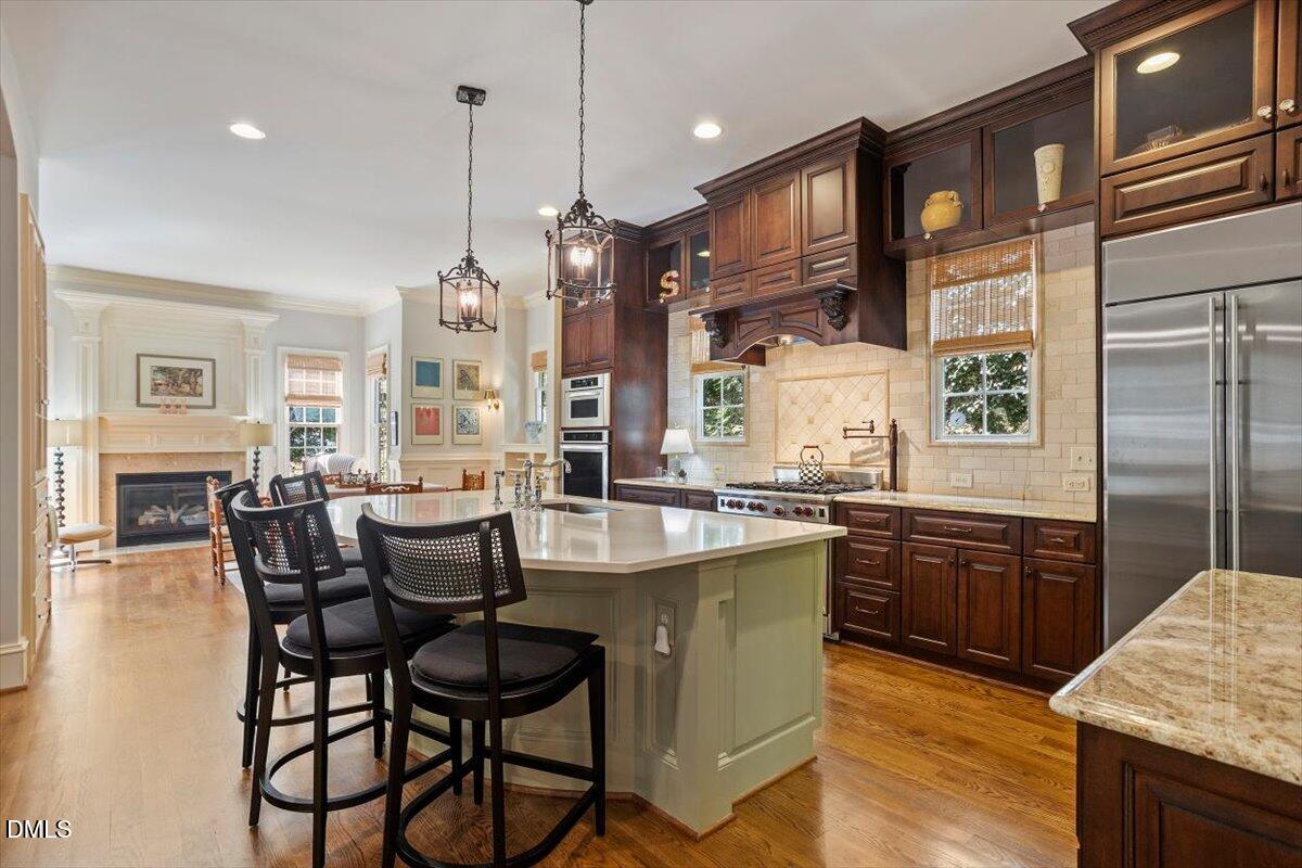 3916 Laurel Manor Court Raleigh, NC 27612 - Photo 11 of 53 a large kitchen with a table and chairs