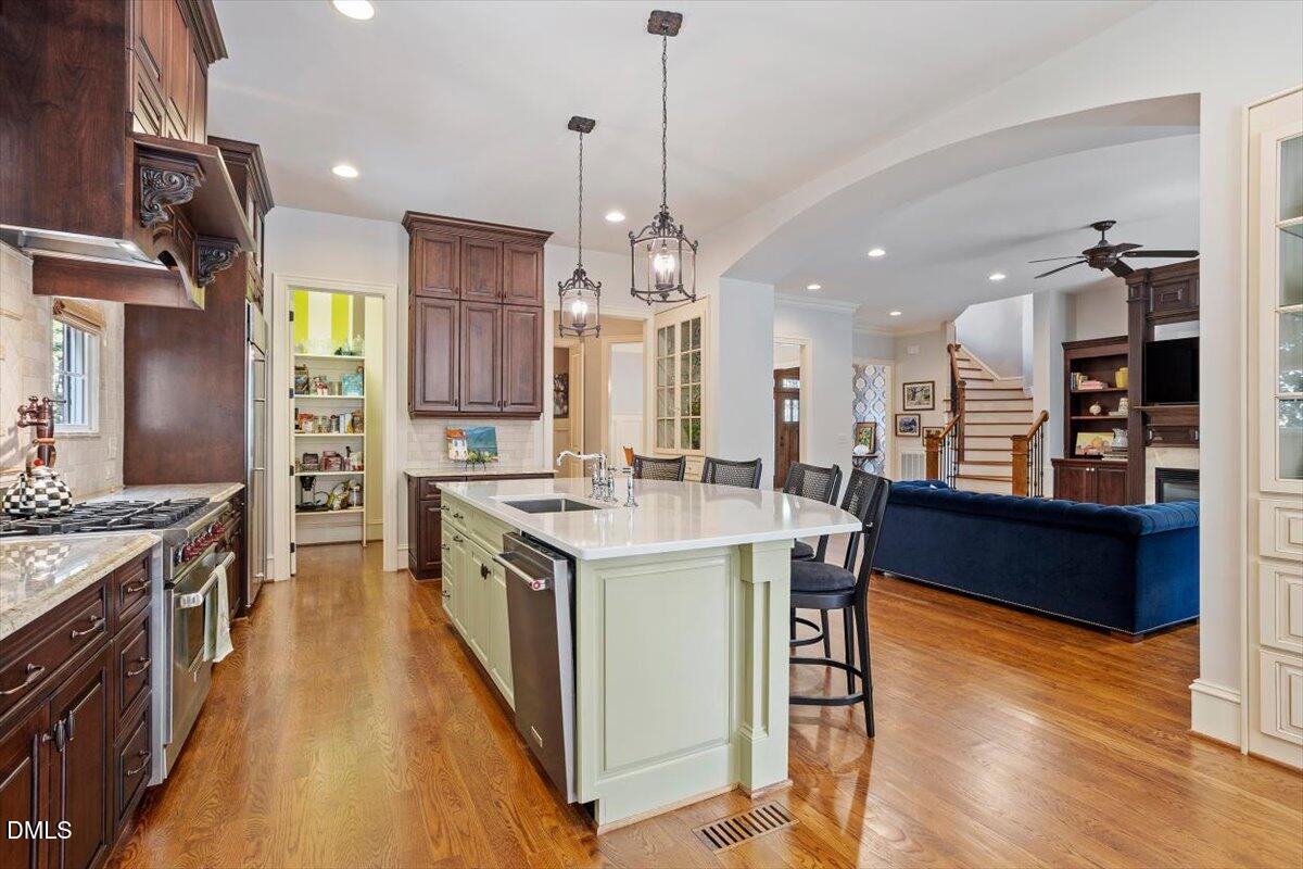3916 Laurel Manor Court Raleigh, NC 27612 - Photo 12 of 53 a kitchen with stainless steel appliances granite countertop a stove oven and a refrigerator