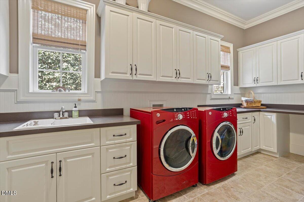 3916 Laurel Manor Court Raleigh, NC 27612 - Photo 17 of 53 a utility room with sink dryer and washer