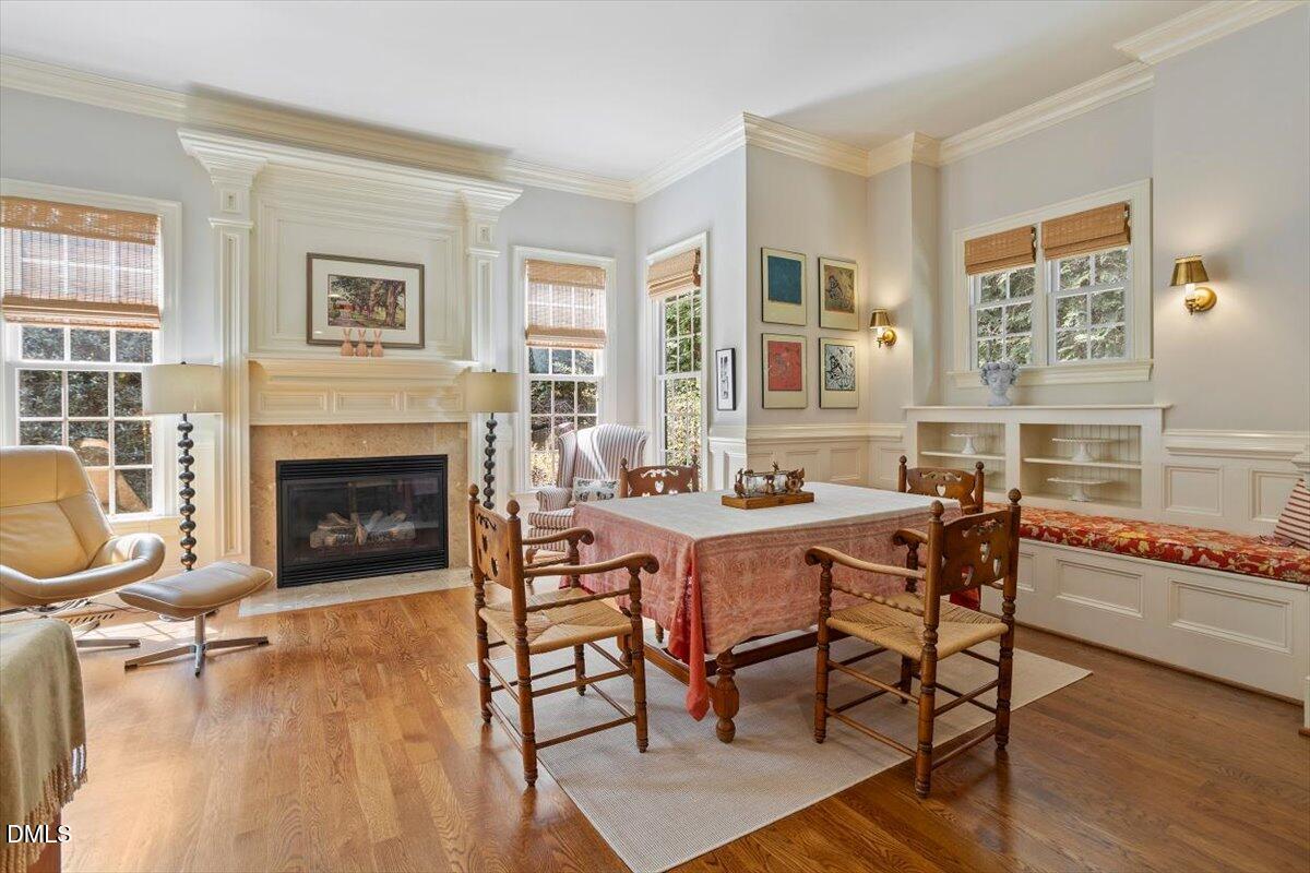 3916 Laurel Manor Court Raleigh, NC 27612 - Photo 18 of 53 a dining room with furniture a fireplace and wooden floor
