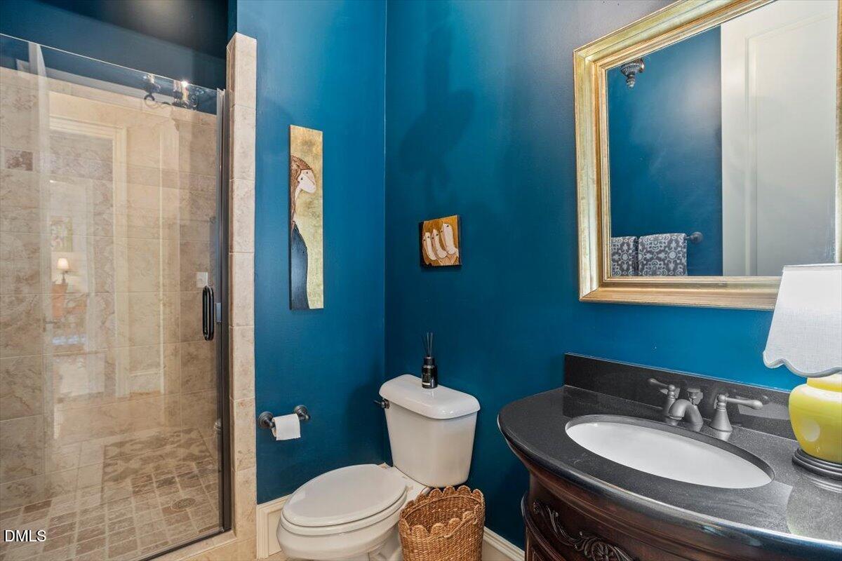 3916 Laurel Manor Court Raleigh, NC 27612 - Photo 22 of 53 a bathroom with a sink a toilet a mirror and shower