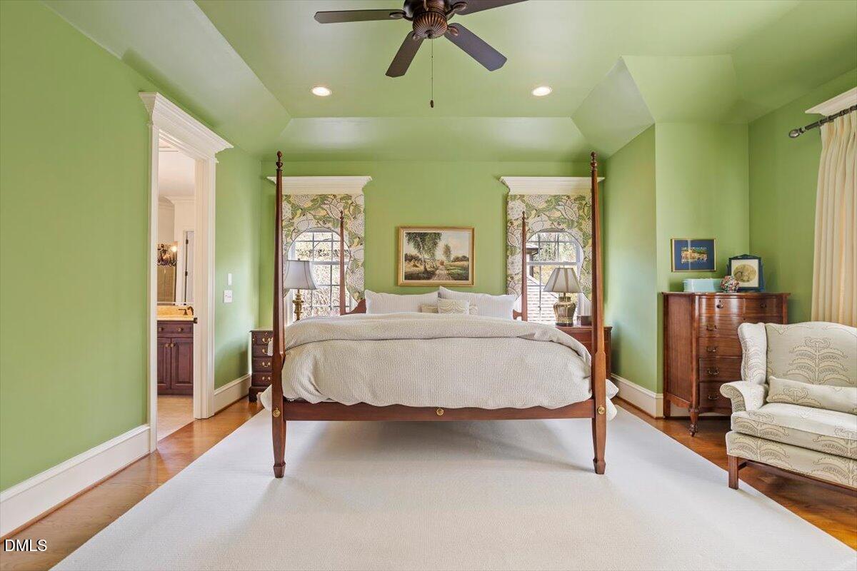 3916 Laurel Manor Court Raleigh, NC 27612 - Photo 25 of 53 a bed sitting in a spacious bedroom next to a window and a chandelier