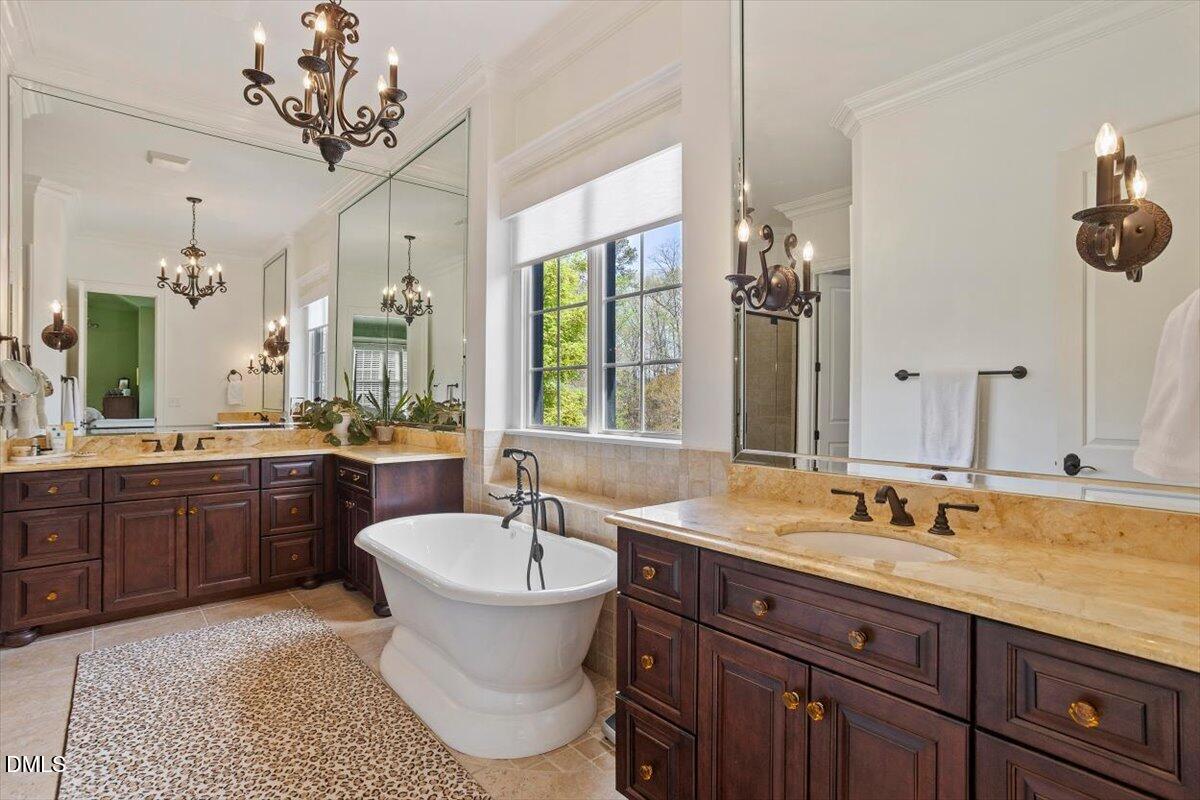 3916 Laurel Manor Court Raleigh, NC 27612 - Photo 26 of 53 a spacious bathroom with a granite countertop sink mirror and bathtub