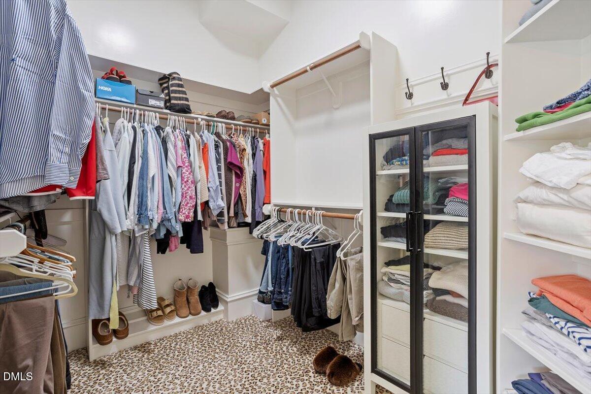3916 Laurel Manor Court Raleigh, NC 27612 - Photo 28 of 53 a view of walk in closet with clothes and shoes