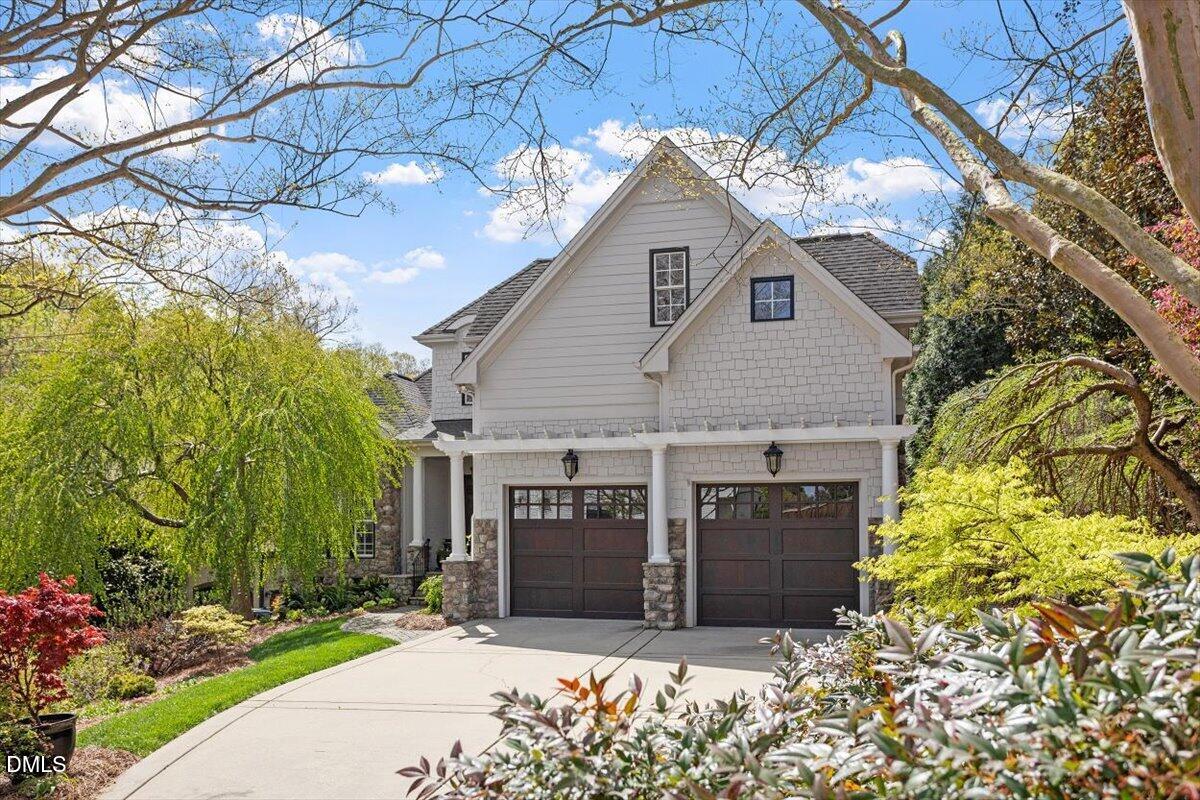 3916 Laurel Manor Court Raleigh, NC 27612 - Photo 2 of 53 a view of a house with wooden fence and large trees
