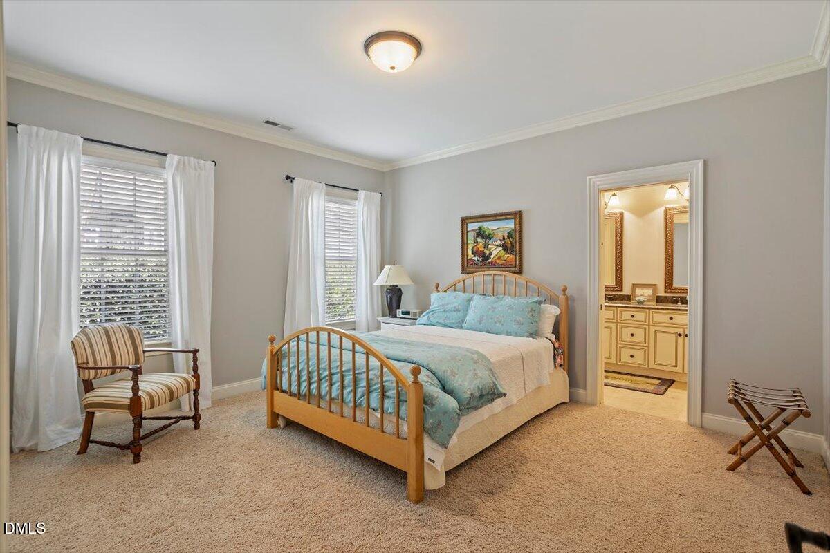 3916 Laurel Manor Court Raleigh, NC 27612 - Photo 32 of 53 a spacious bedroom with a bed and a couch