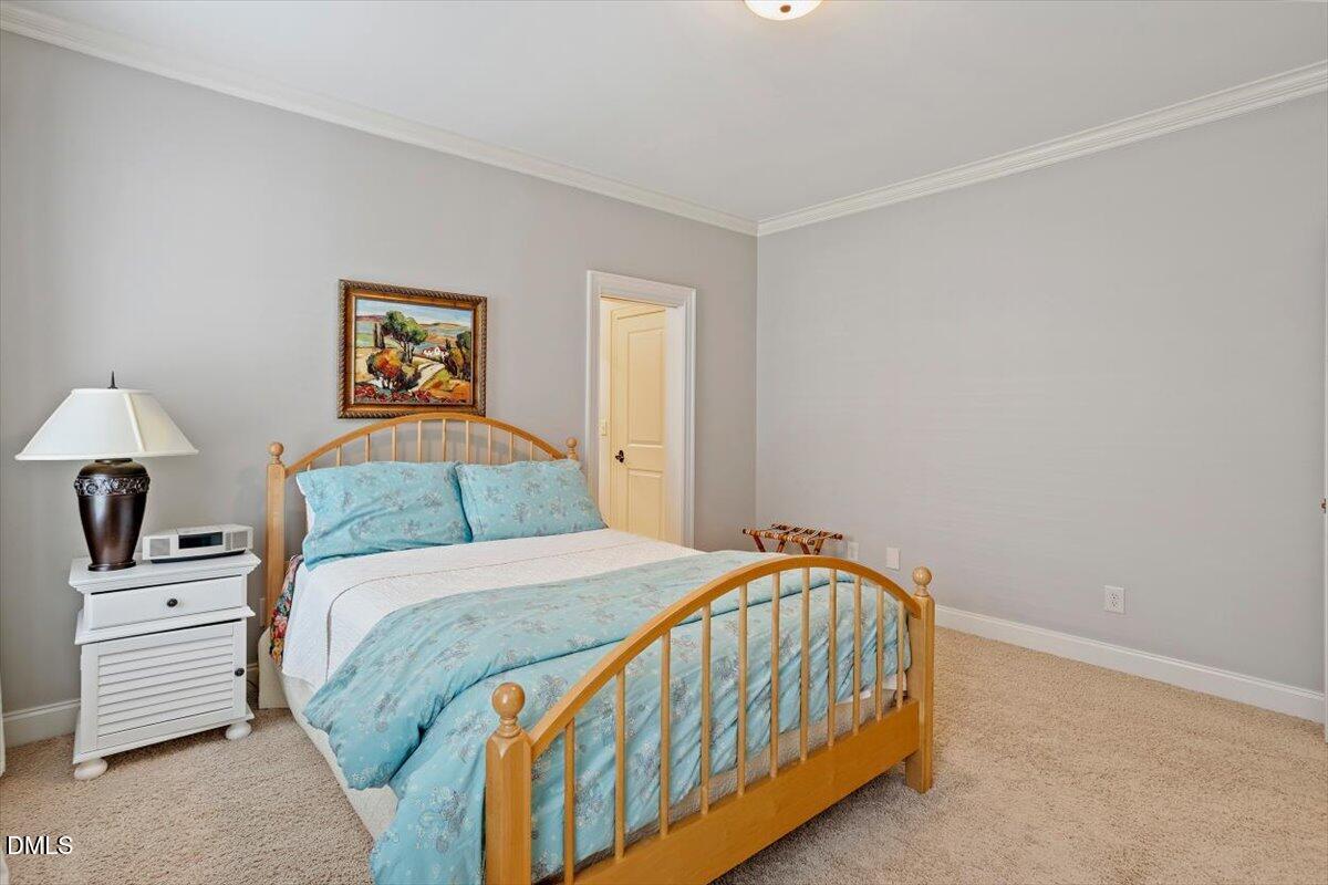 3916 Laurel Manor Court Raleigh, NC 27612 - Photo 33 of 53 a bedroom with a bed and a painting on the wall