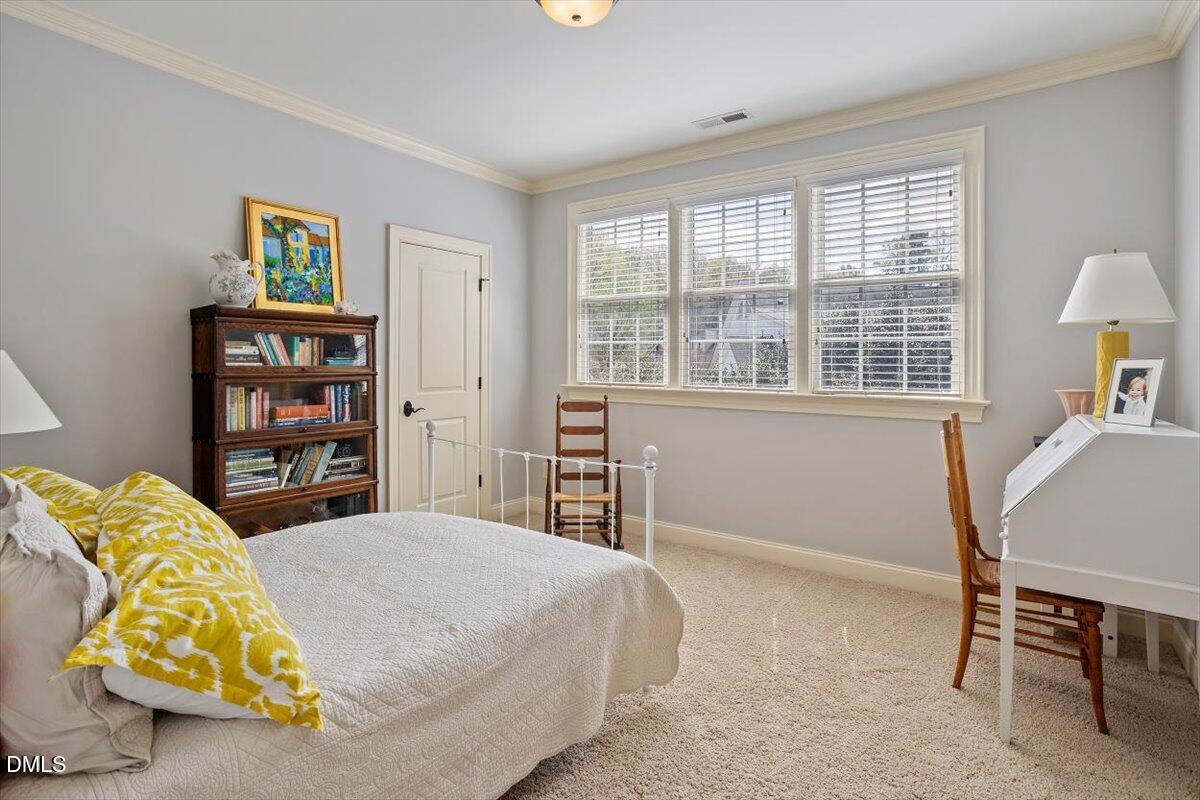 3916 Laurel Manor Court Raleigh, NC 27612 - Photo 34 of 53 a bedroom with bed and a chair