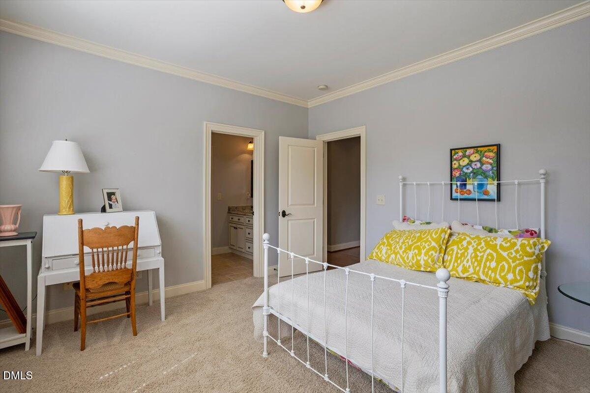 3916 Laurel Manor Court Raleigh, NC 27612 - Photo 35 of 53 a bedroom with a bed and a table in it