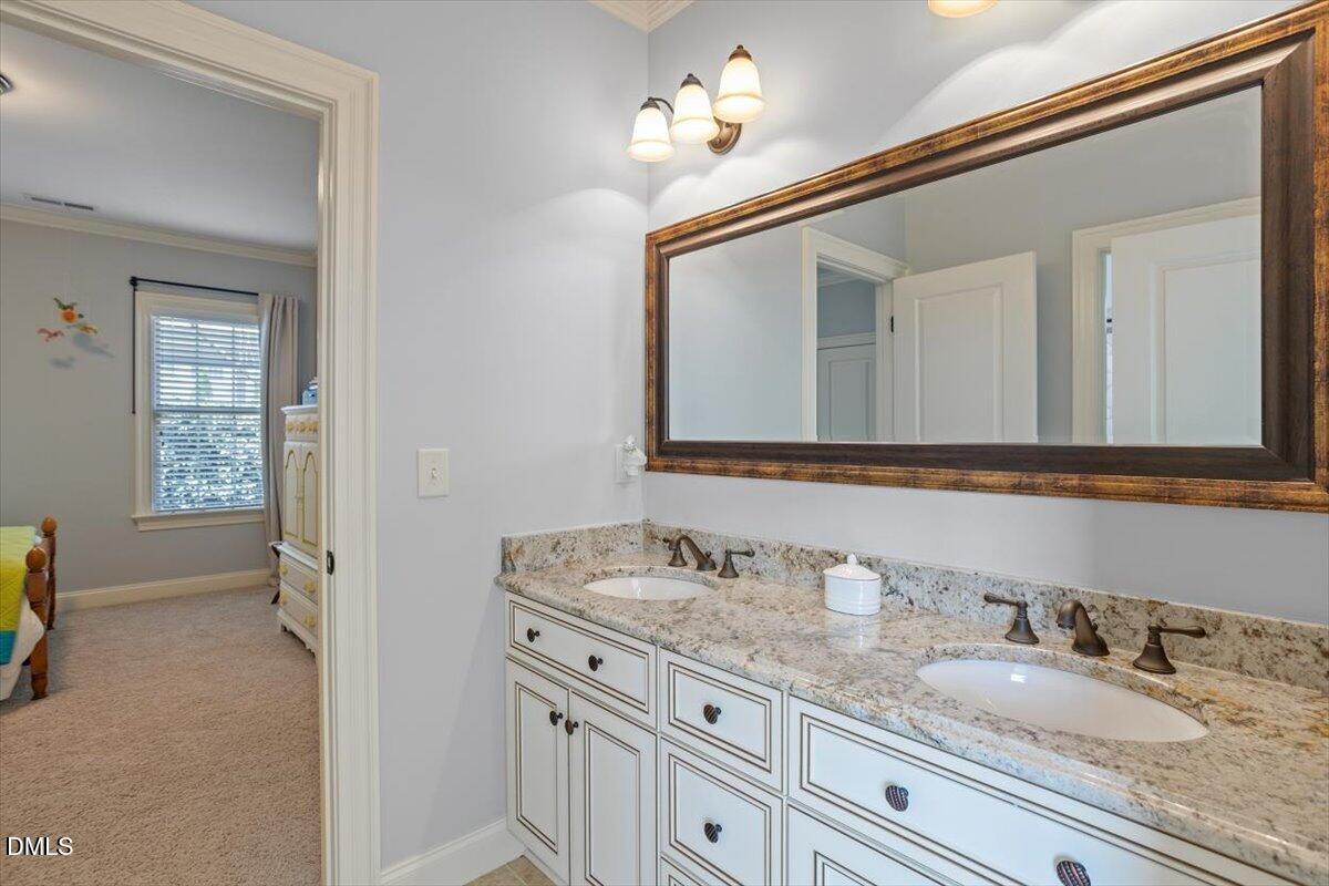 3916 Laurel Manor Court Raleigh, NC 27612 - Photo 36 of 53 a en suite bathroom with a granite countertop double vanity sink and a mirror