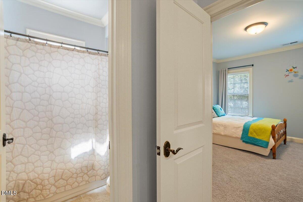 3916 Laurel Manor Court Raleigh, NC 27612 - Photo 37 of 53 a bedroom with a bed and a mirror