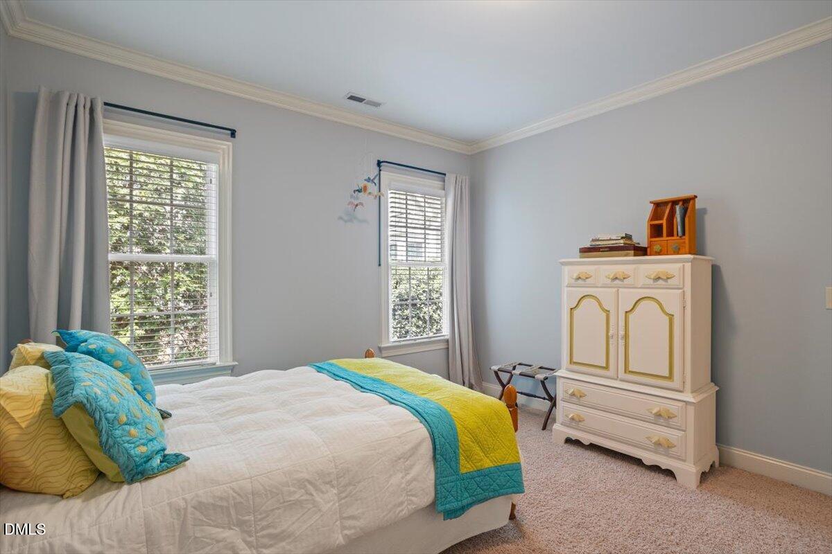 3916 Laurel Manor Court Raleigh, NC 27612 - Photo 39 of 53 a bedroom with a bed and a window