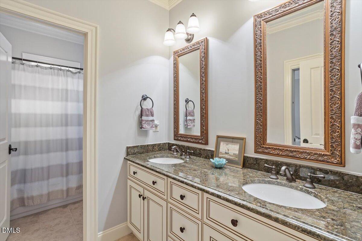 3916 Laurel Manor Court Raleigh, NC 27612 - Photo 40 of 53 a bathroom with double sink and a mirror