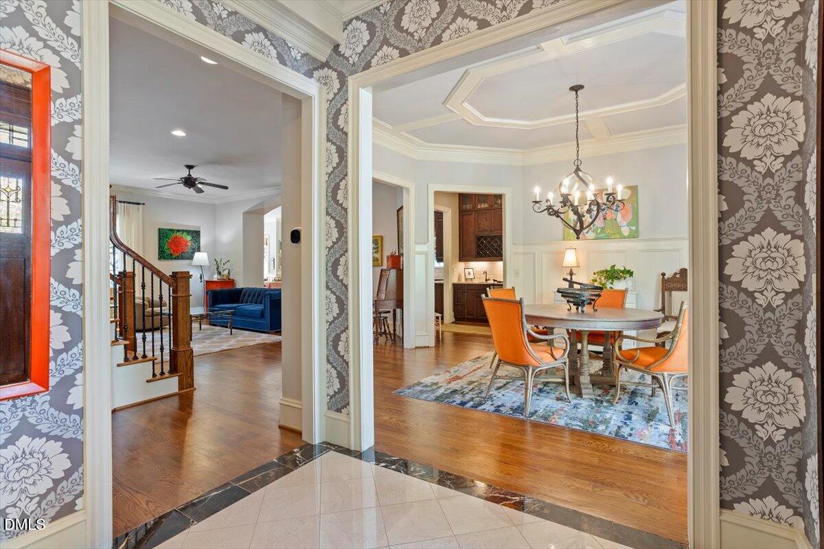 3916 Laurel Manor Court Raleigh, NC 27612 - Photo 4 of 53 a view of a dining room and livingroom with furniture wooden floor a chandelier