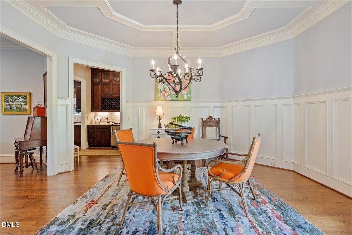 3916 Laurel Manor Court Raleigh, NC 27612 - Photo 6 of 53 a view of a dining room with furniture wooden floor and chandelier