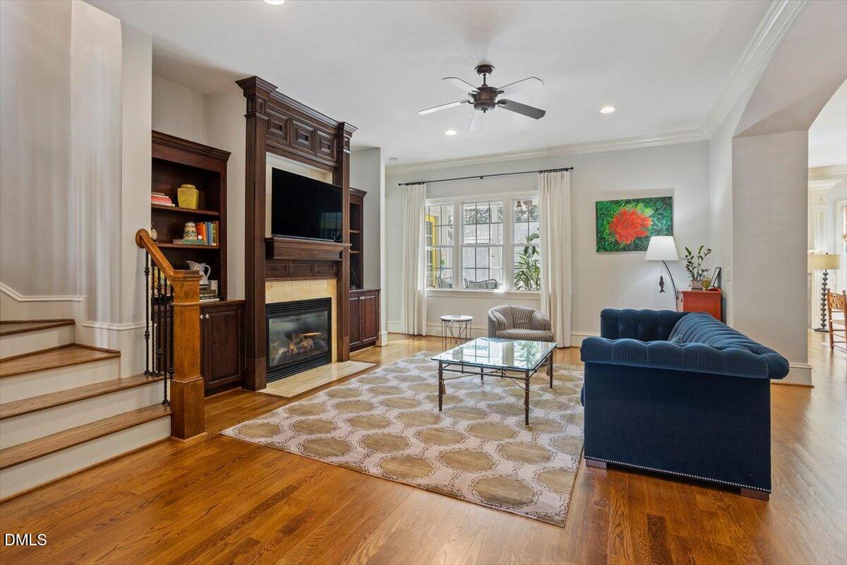 3916 Laurel Manor Court Raleigh, NC 27612 - Photo 8 of 53 a living room with furniture and a flat screen tv
