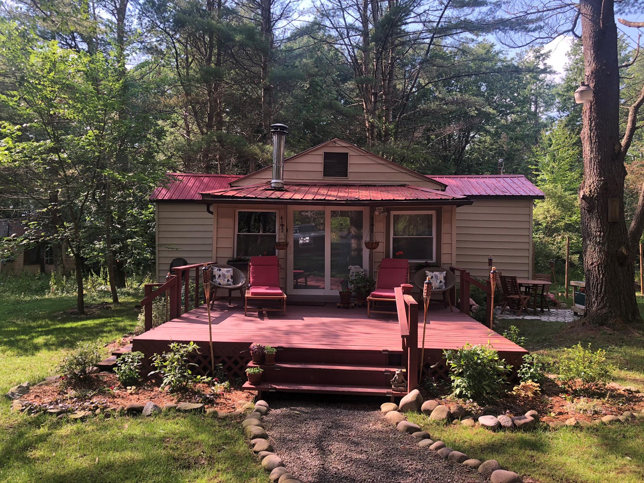 147 Hasbrouck A Road Loch Sheldrake, NY 12747 - Photo 1 of 1 Back of property with a wooden deck, a yard, and metal roof