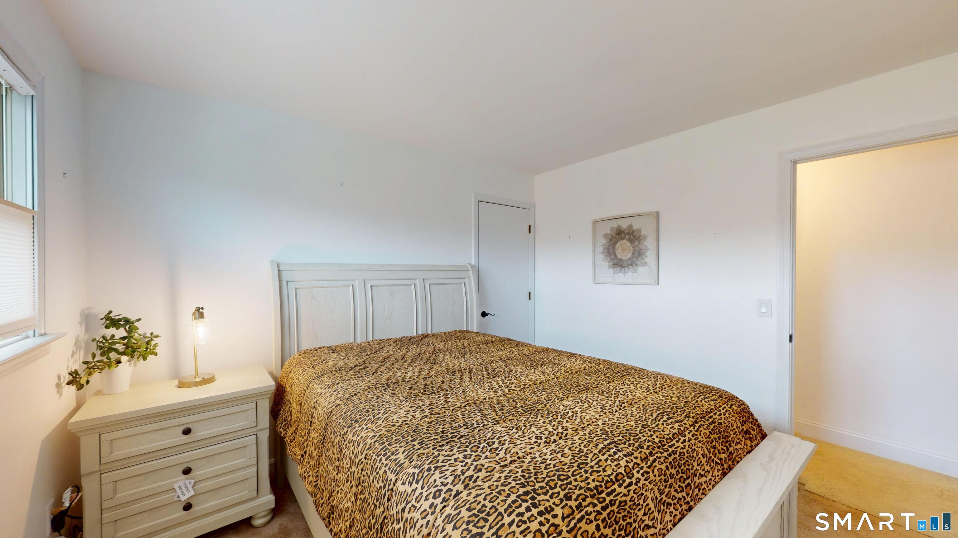 29 Deer Ridge Road Stonington, CT 06378 - Photo 11 of 35 a bedroom with a bed and a dresser