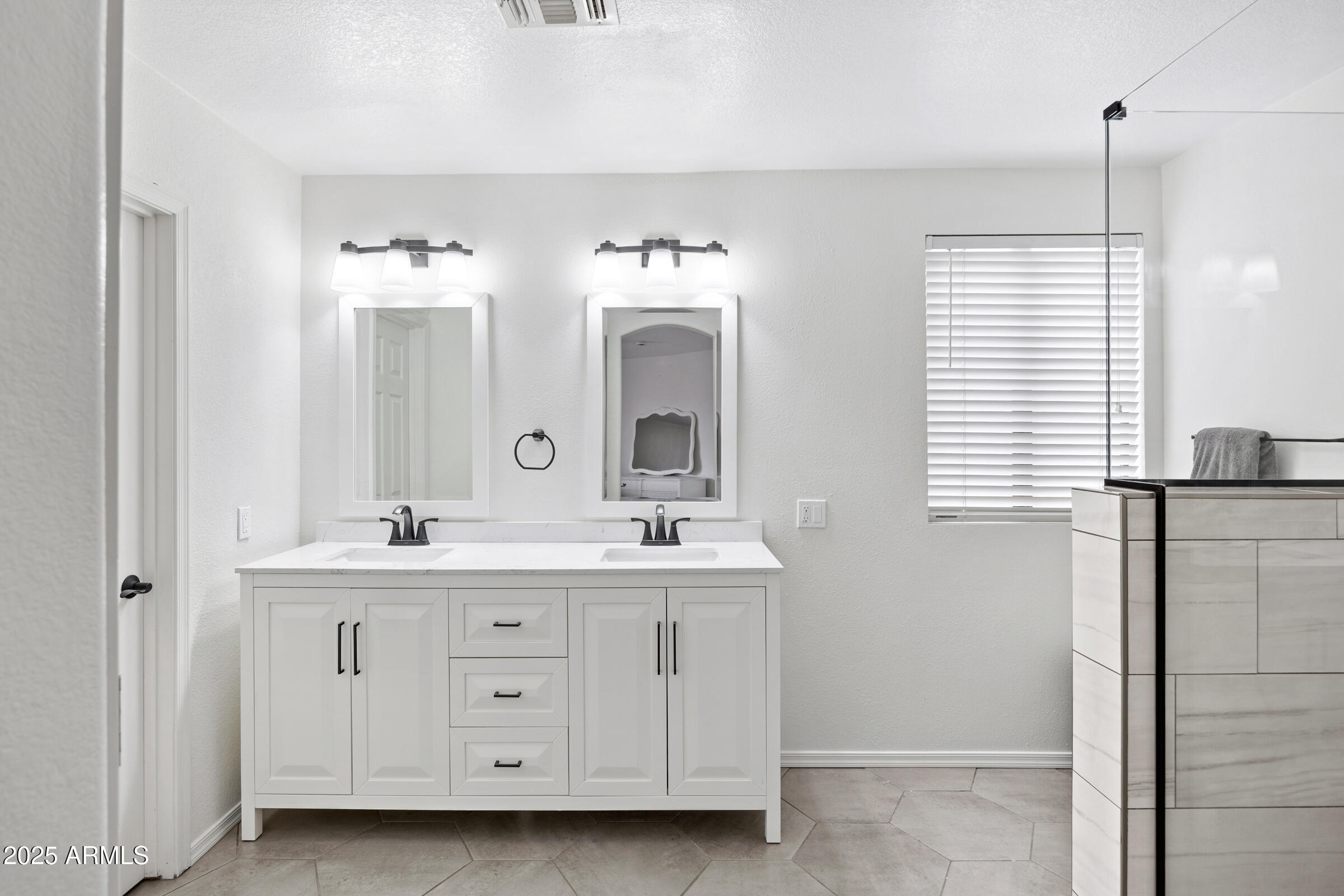 2027 East Parkside Lane Phoenix, AZ 85024 - Photo 11 of 43 a spacious bathroom with a double vanity sink a mirror a and a window