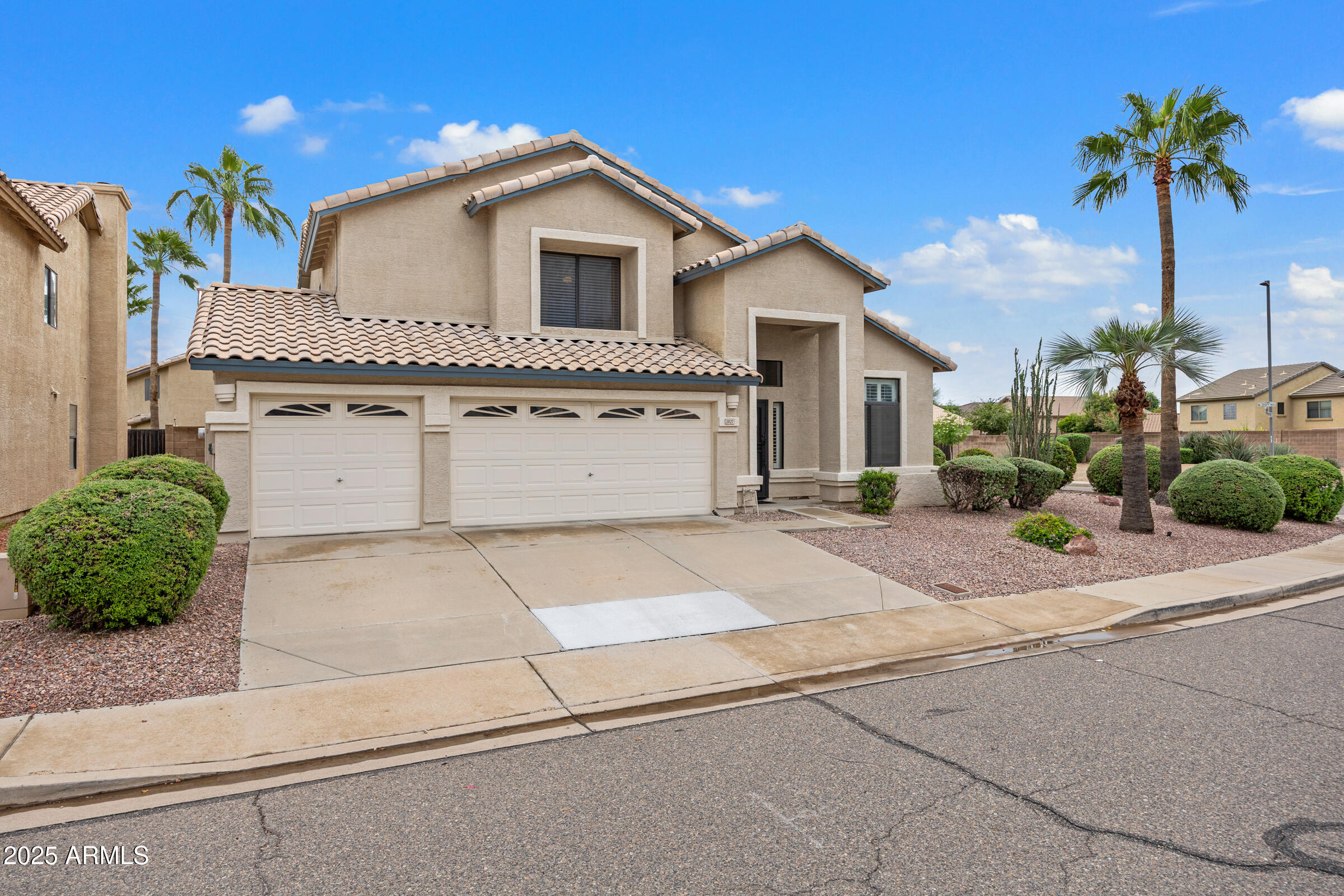 2027 East Parkside Lane Phoenix, AZ 85024 - Photo 2 of 43 a front view of a house with a yard and garage