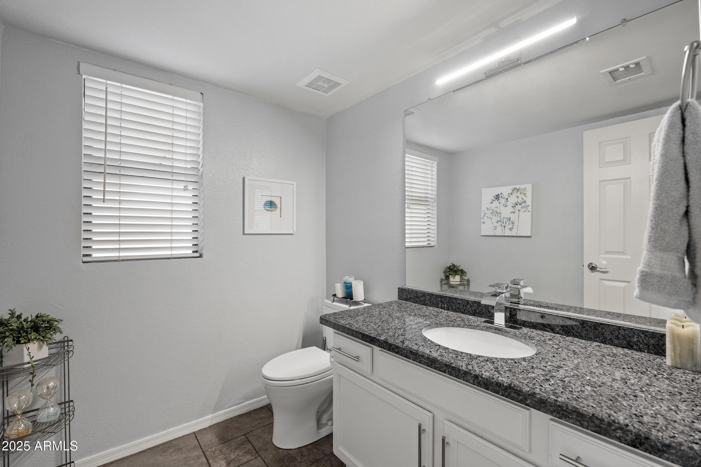 2027 East Parkside Lane Phoenix, AZ 85024 - Photo 22 of 43 a bathroom with a granite countertop sink and a mirror
