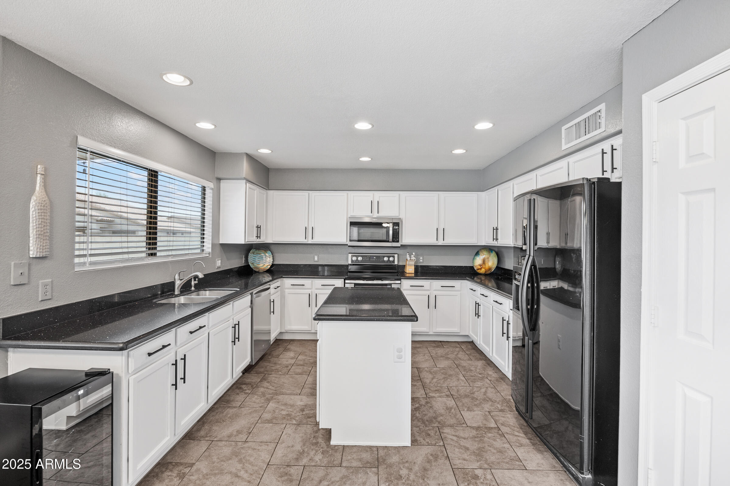2027 East Parkside Lane Phoenix, AZ 85024 - Photo 24 of 43 a kitchen with a sink a counter top space stainless steel appliances and cabinets