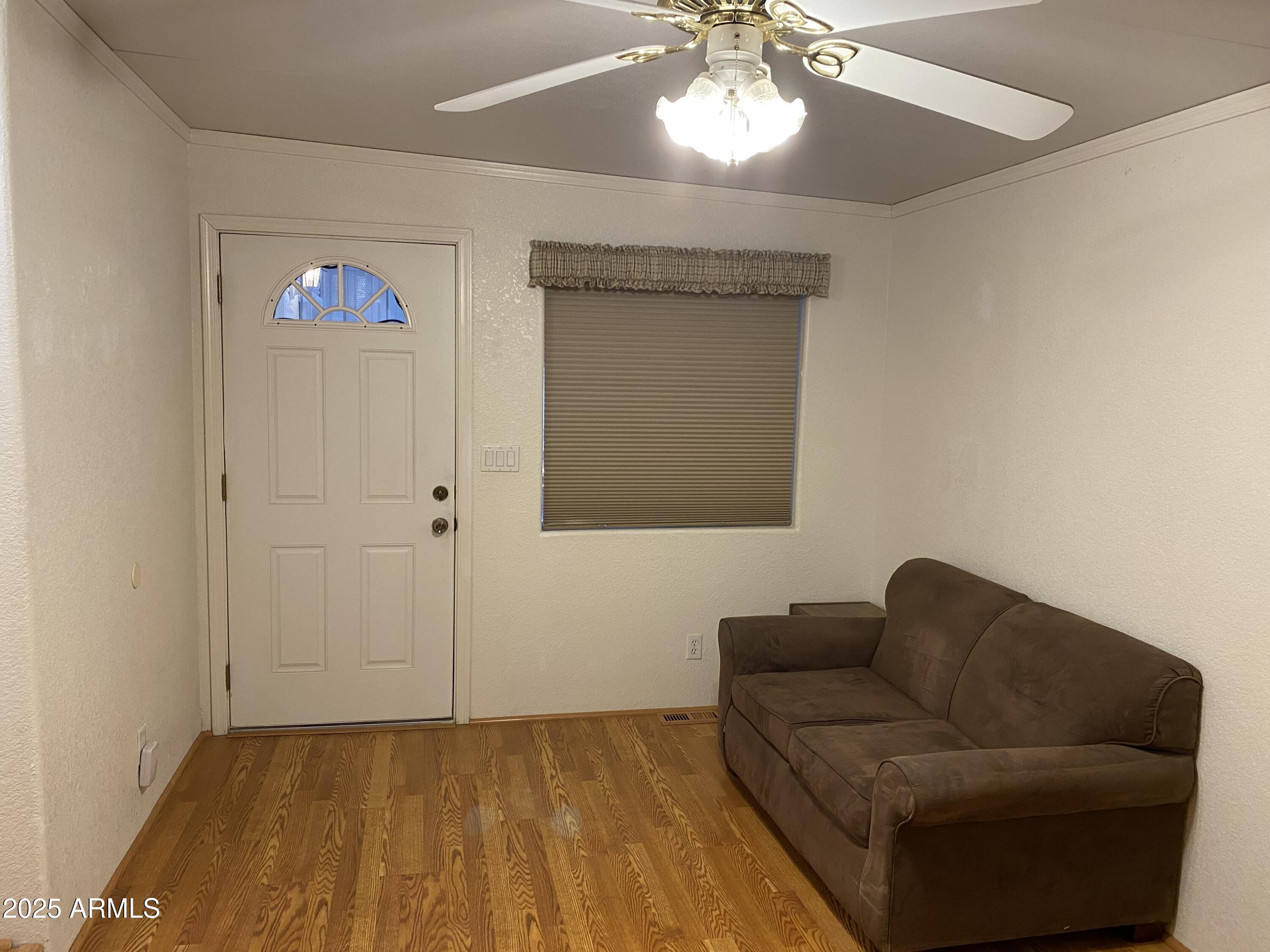 112 Kaolin Drive Apache Junction, AZ 85119 - Photo 19 of 42 a living room with furniture and a chandelier