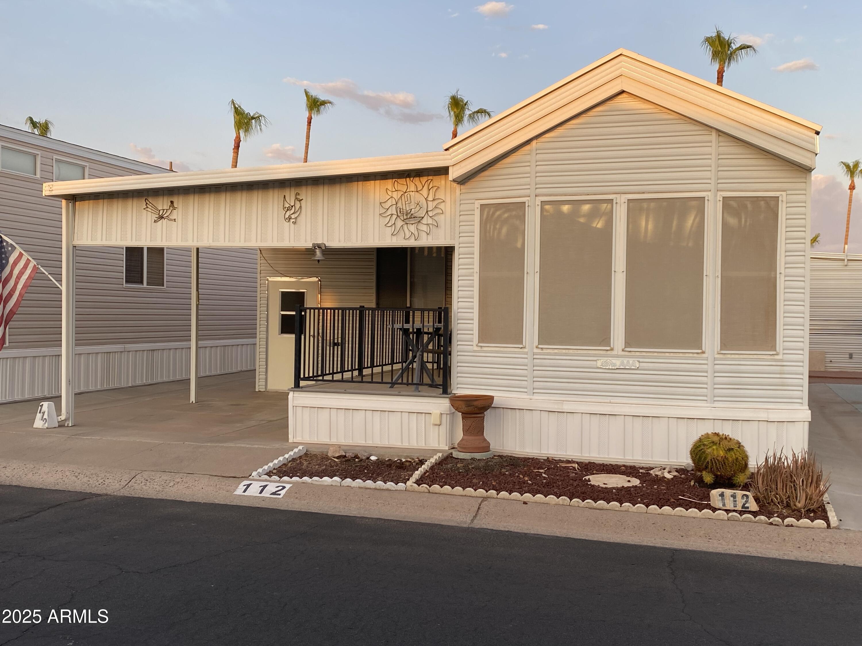 112 Kaolin Drive Apache Junction, AZ 85119 - Photo 2 of 42 a front view of a house with a garage