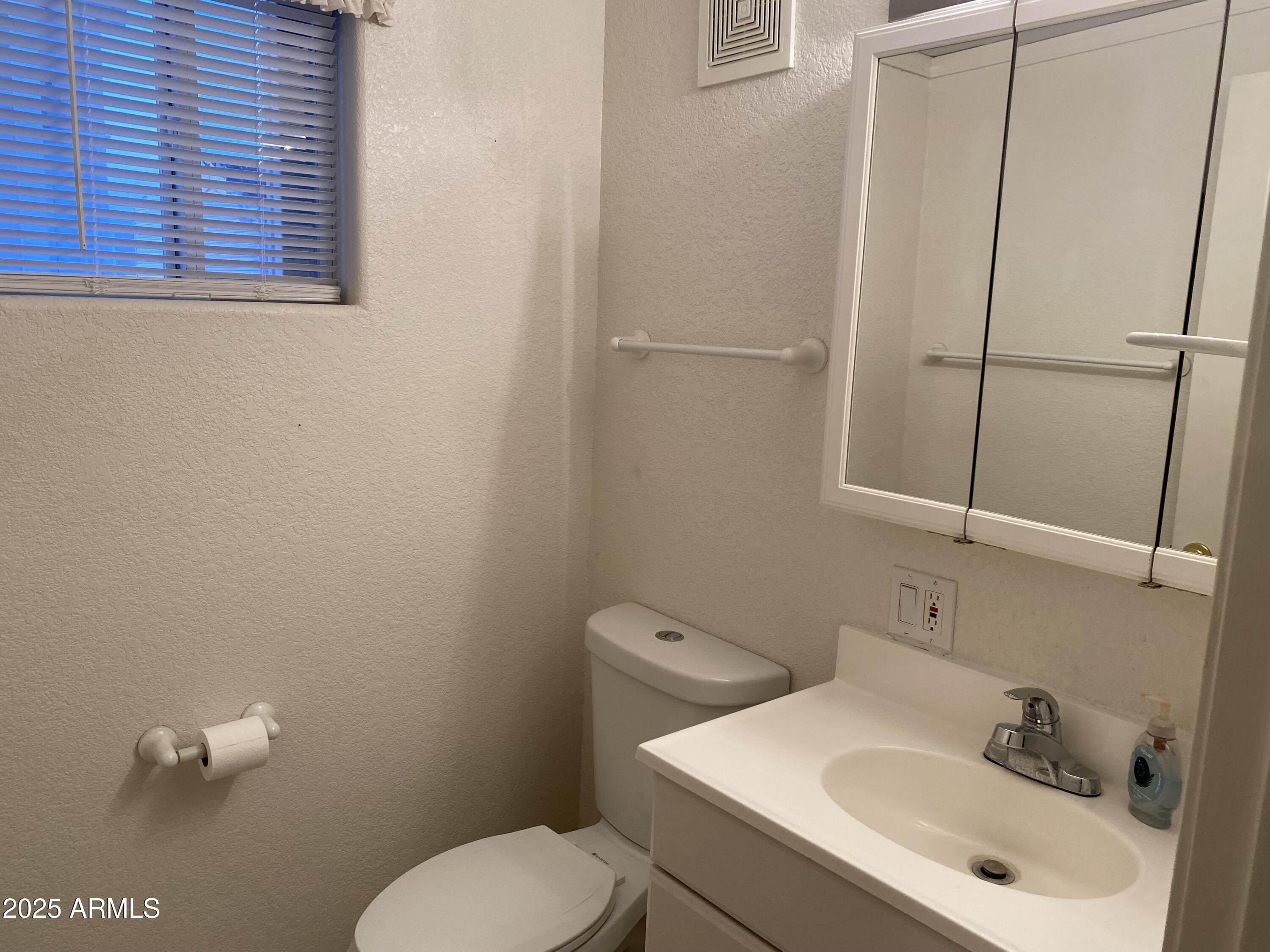 112 Kaolin Drive Apache Junction, AZ 85119 - Photo 27 of 42 a bathroom with a sink a toilet and a mirror