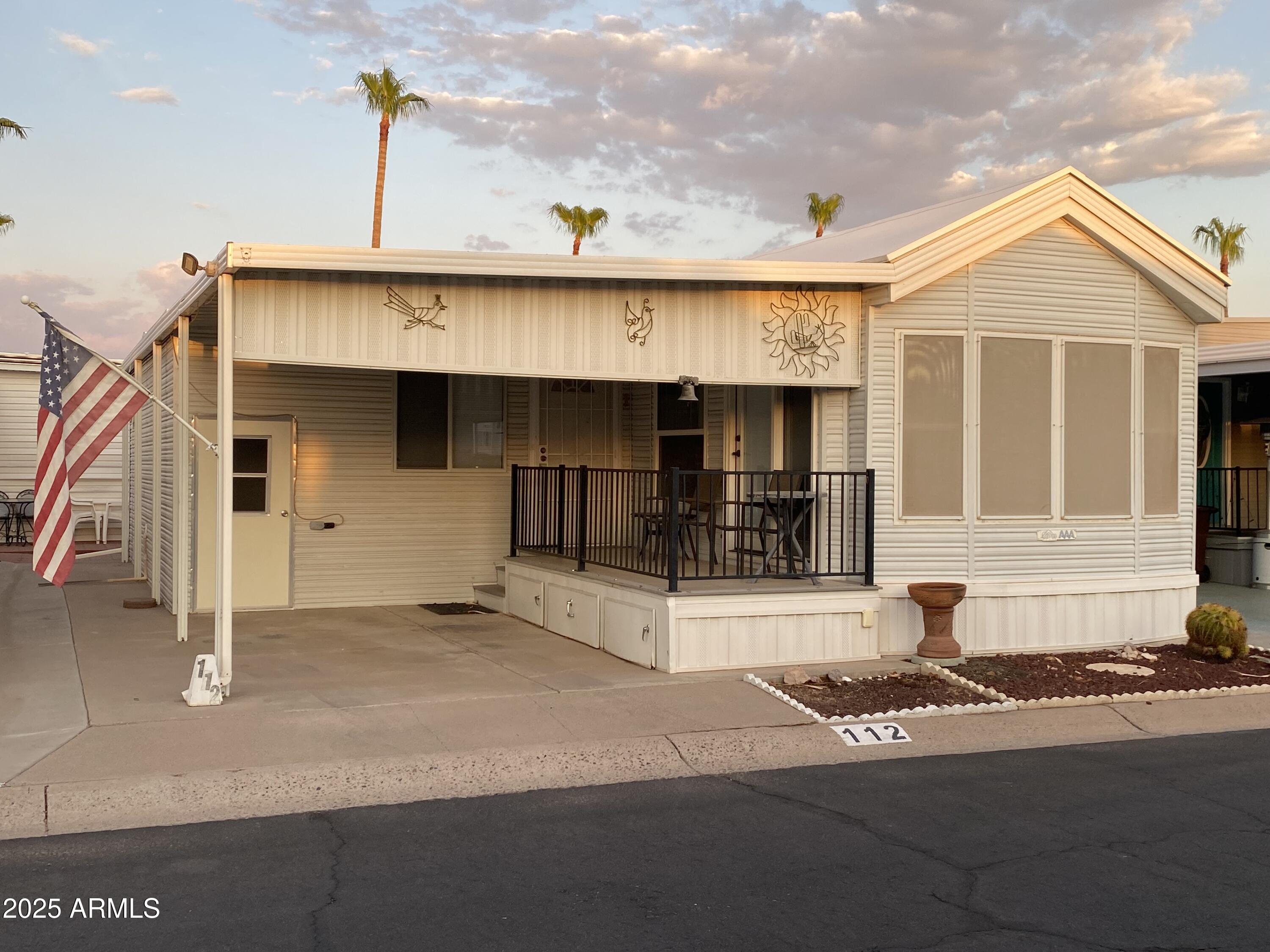 112 Kaolin Drive Apache Junction, AZ 85119 - Photo 3 of 42 a front view of a house with a garage
