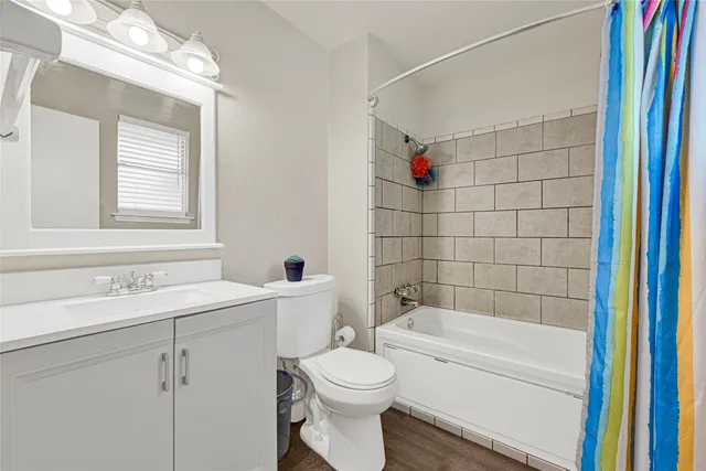 a bedroom with a bed a chandelier and a window