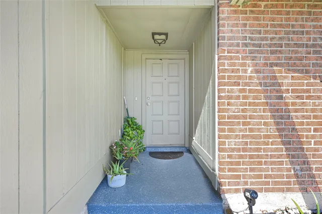 a living room with furniture and a dining table with wooden floor